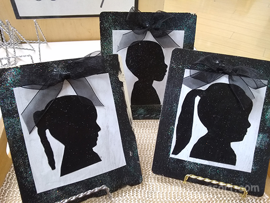 I found plain wood frames at a craft store. The children painted them and added glitter. I cut out their photos and traced them onto black card stock, which I then cut out,  ready to be added to a piece of white card stock and then this was glued onto the painted black frame. 
